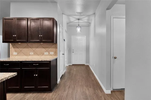 a kitchen with stainless steel appliances a sink a stove a microwave a counter top space and cabinets