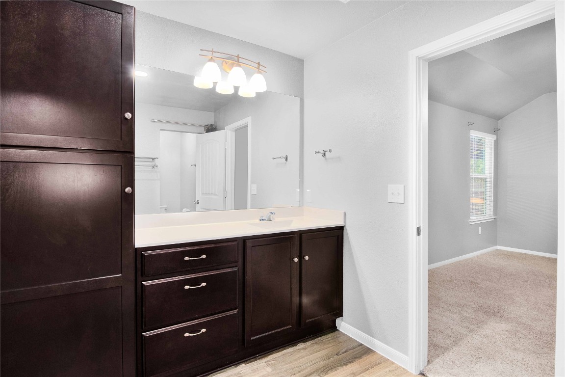 704 Red Tails Drive Austin, TX 78725 - Photo 23 of 37 a bathroom with a sink and a mirror