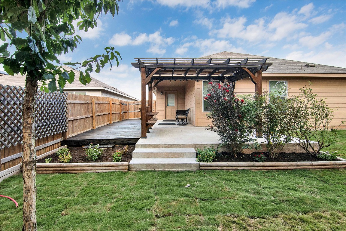 704 Red Tails Drive Austin, TX 78725 - Photo 28 of 37 a view of a white house with a big yard and potted plants