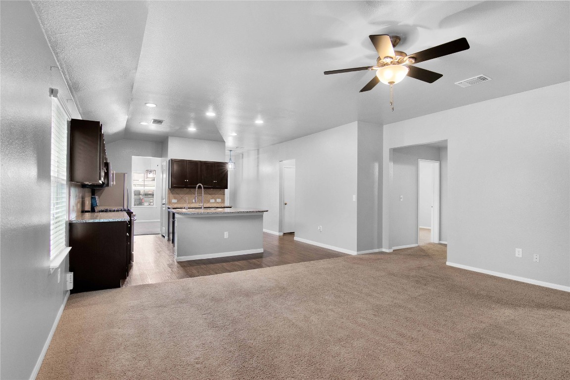 704 Red Tails Drive Austin, TX 78725 - Photo 6 of 37 a view of kitchen with microwave refrigerator and stove