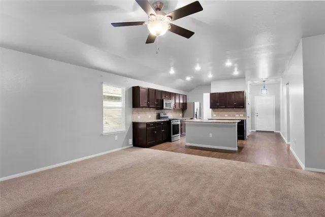 a view of a patio with table and chairs and potted plants
