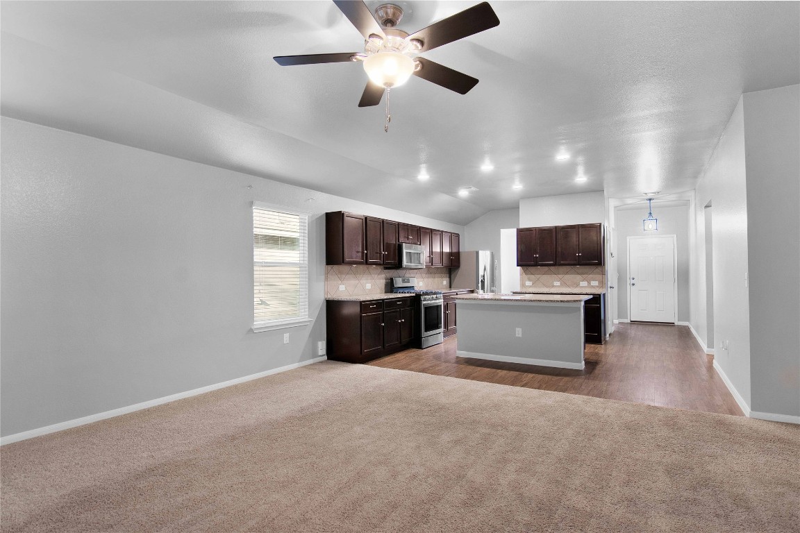 704 Red Tails Drive Austin, TX 78725 - Photo 37 of 37 a view of a kitchen with microwave and cabinets