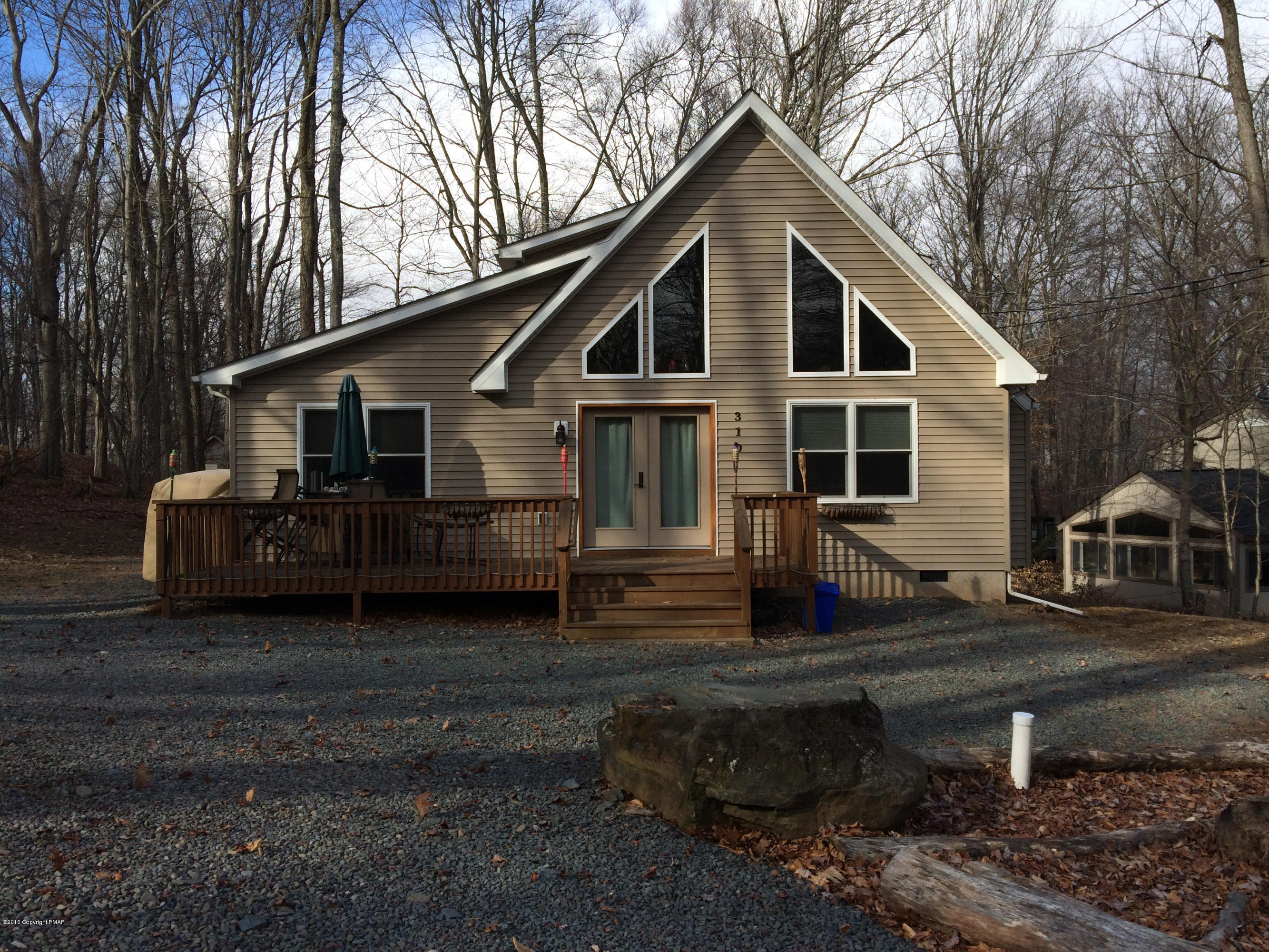 310 Fawn Road Pocono Lake, PA 18347 - Photo 1 of 26 a front view of a house with garden