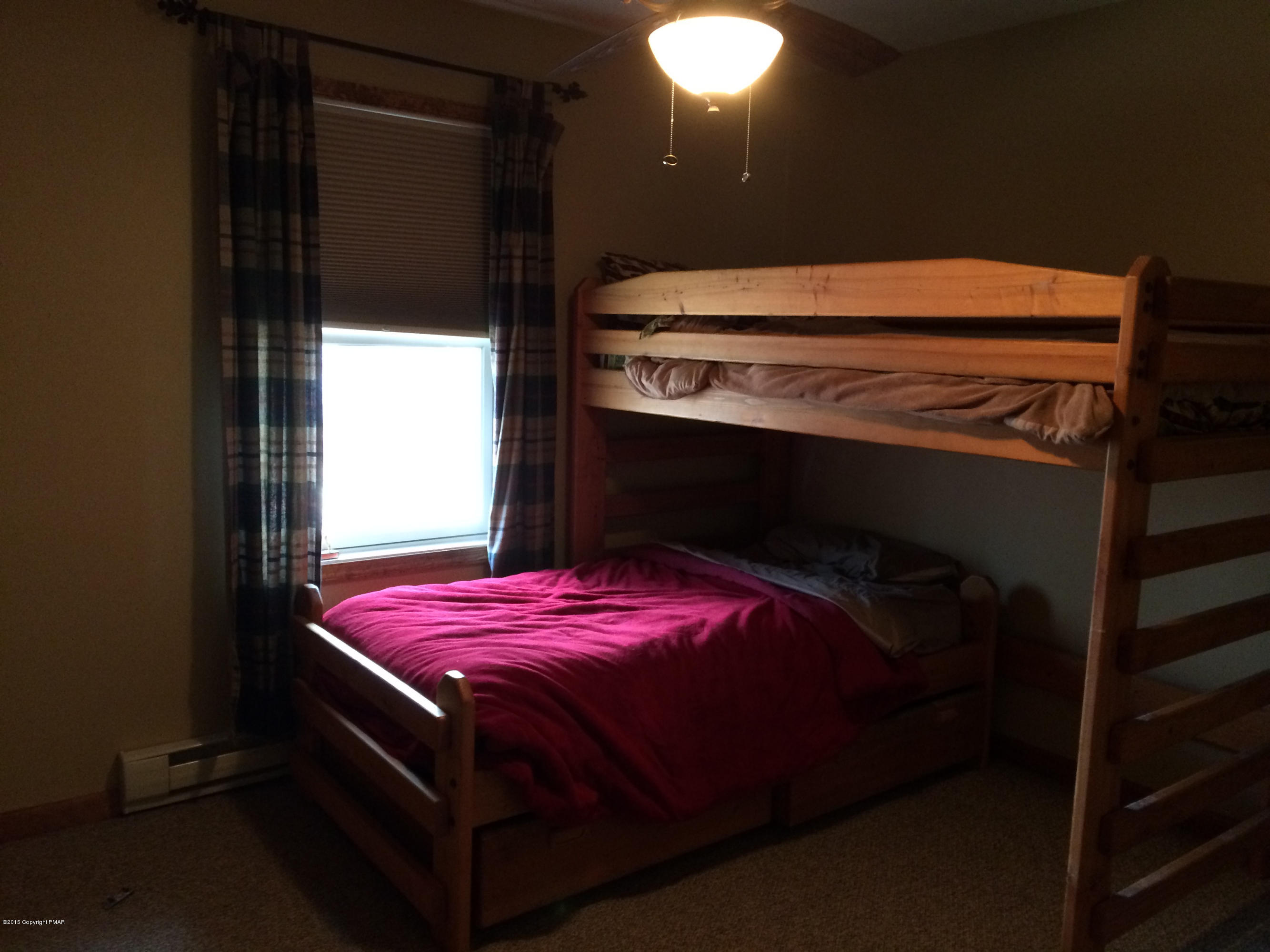 310 Fawn Road Pocono Lake, PA 18347 - Photo 16 of 26 a bed sitting in a bedroom next to a window