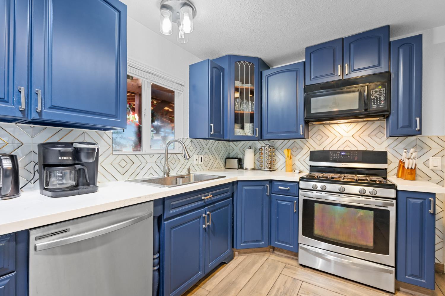 2409 Rio Oso Road Rio Oso, CA 95674 - Photo 15 of 67 a kitchen with a sink stove and microwave