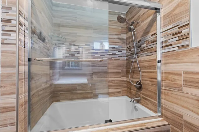 a view of patio with table and chairs and wooden fence