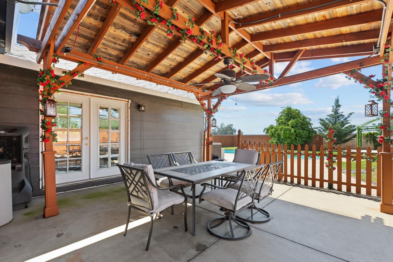 2409 Rio Oso Road Rio Oso, CA 95674 - Photo 30 of 67 a view of a patio with table and chairs with wooden floor and fence