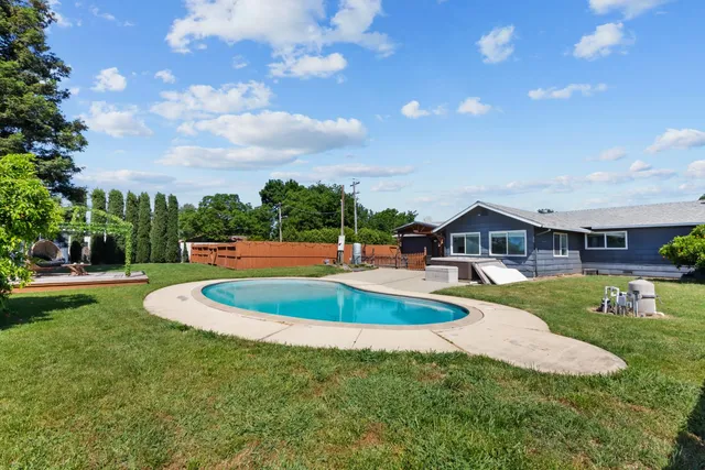 a view of a swimming pool and a yard