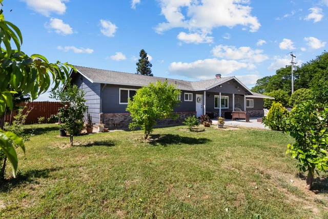 an aerial view of a houses with outdoor space and ocean view