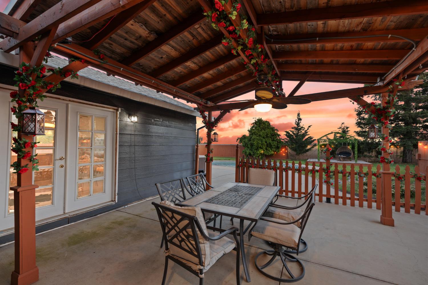 2409 Rio Oso Road Rio Oso, CA 95674 - Photo 5 of 67 a view of a patio with table and chairs with wooden floor and fence