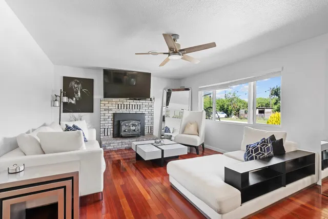 a living room with furniture fireplace and flat screen tv