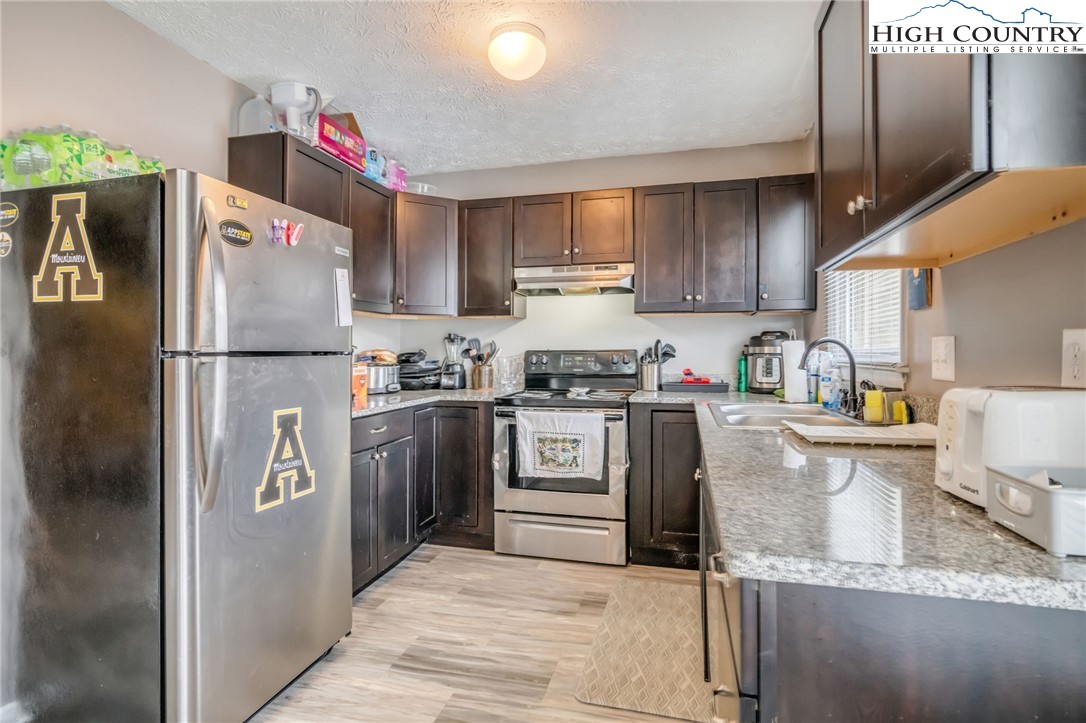 194 Carriage Lamp Court Boone, NC 28607 - Photo 7 of 26 a kitchen with granite countertop a refrigerator and a sink
