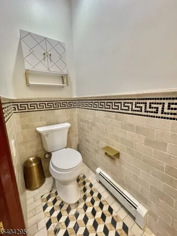 a spacious bedroom with a bed and wooden floor