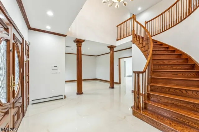 a view of entryway with wooden floor and stairs