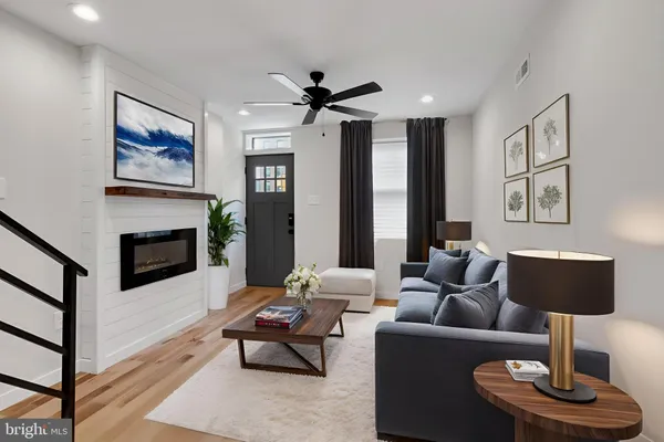 a living room with furniture and a fireplace