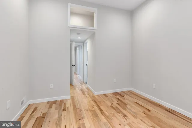 a view of a room with wooden floor and a sink
