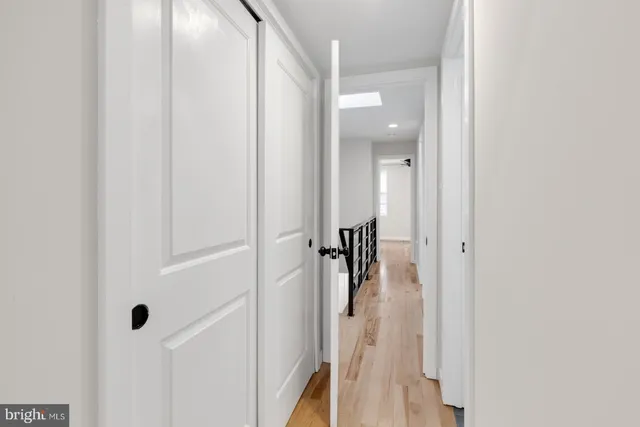 a view of a hallway with a room that has a glass door shower