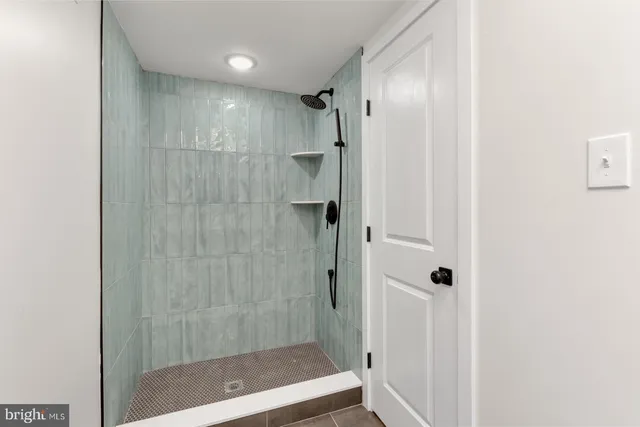 a bathroom with a shower and a glass door