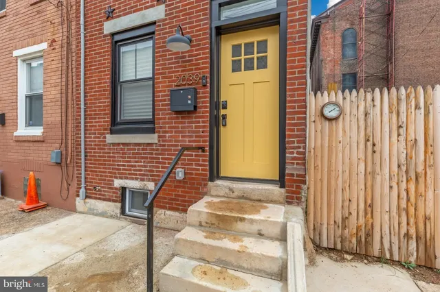 a front view of a house with a iron gate