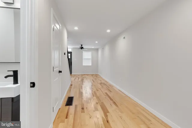 a view of hallway with wooden floor