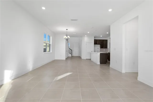 a view of a kitchen with a sink and a refrigerator