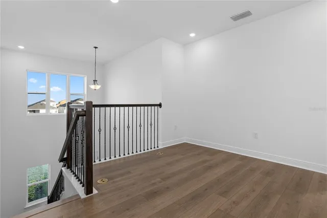 a view of a hallway with wooden floor