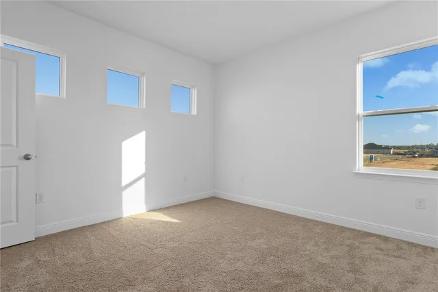 a view of an empty room and a window