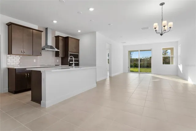 a view of a kitchen with a sink and a refrigerator