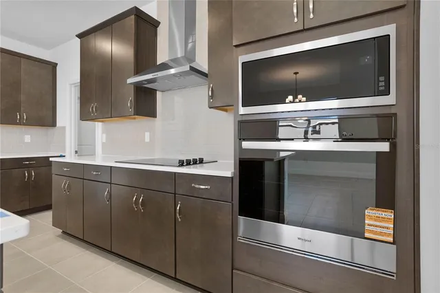 a kitchen with stainless steel appliances granite countertop a stove and a microwave