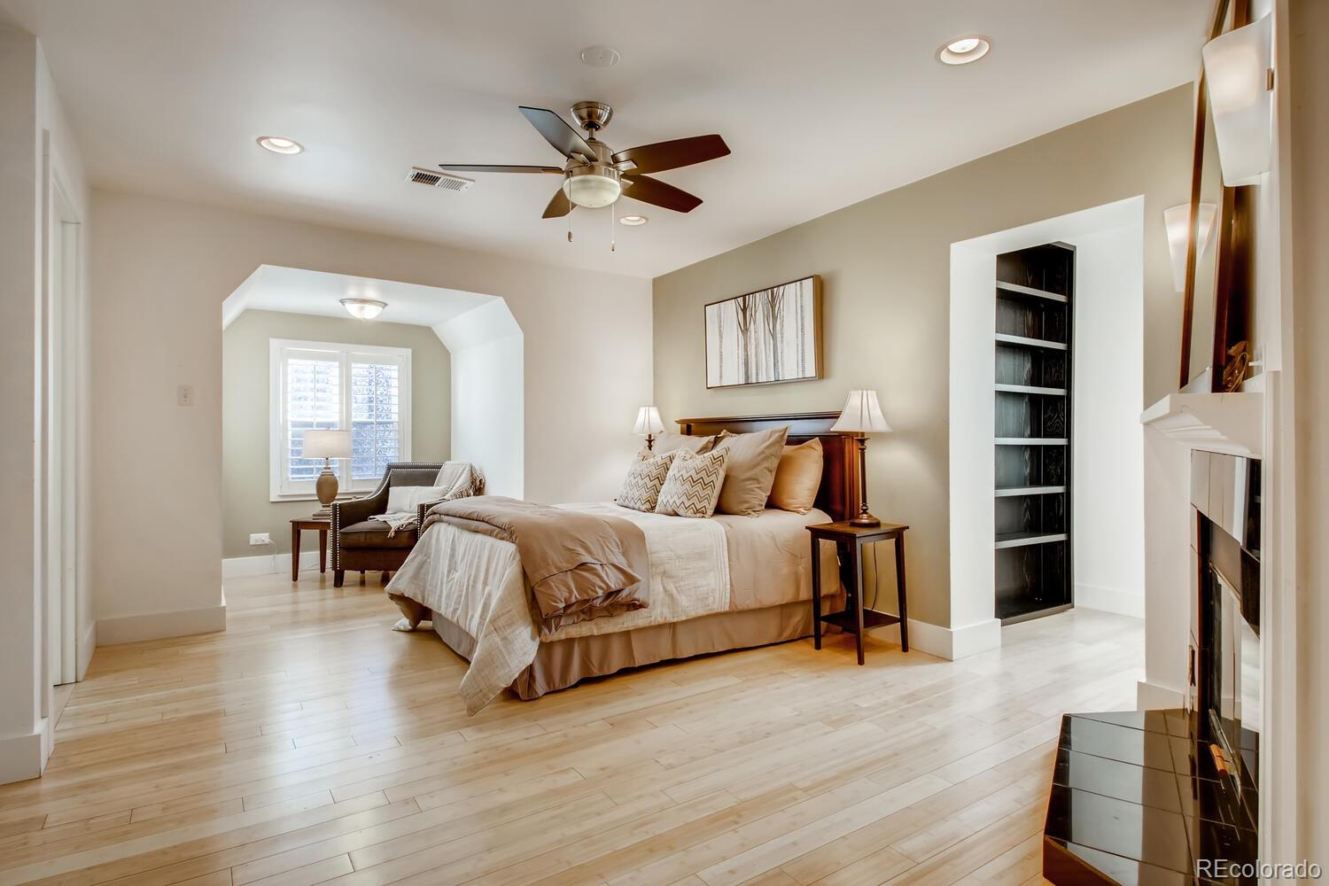 1635 Gilpin Street Denver, CO 80218 - Photo 17 of 39 a spacious bedroom with a bed and a chandelier