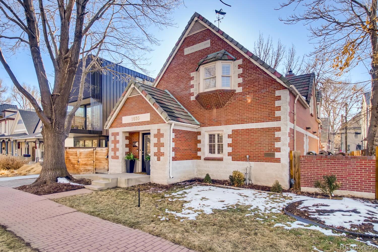 1635 Gilpin Street Denver, CO 80218 - Photo 2 of 39 a view of a house with snow on the road
