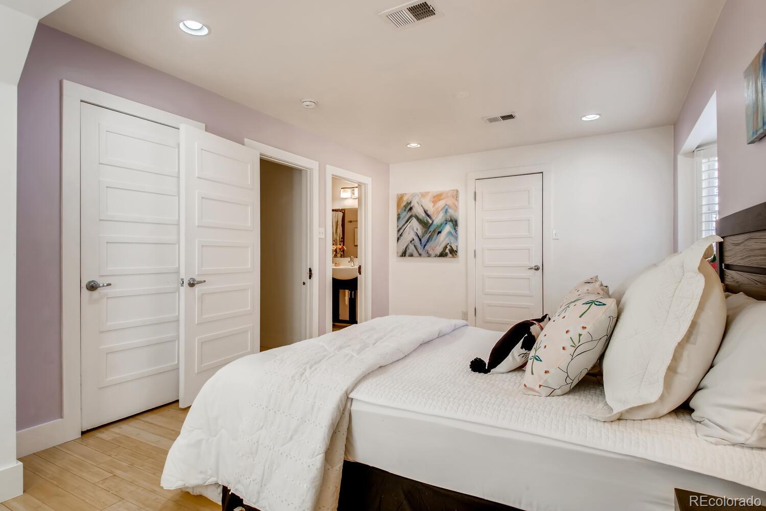 1635 Gilpin Street Denver, CO 80218 - Photo 22 of 39 a bedroom with a bed and a wooden floor
