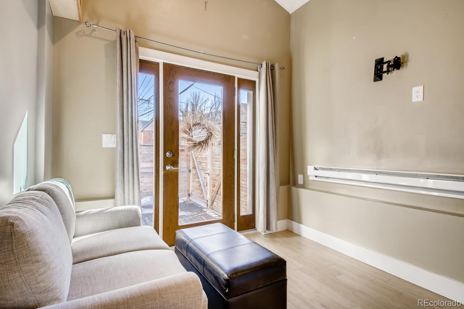 1635 Gilpin Street Denver, CO 80218 - Photo 27 of 39 a living room with a couch and a window