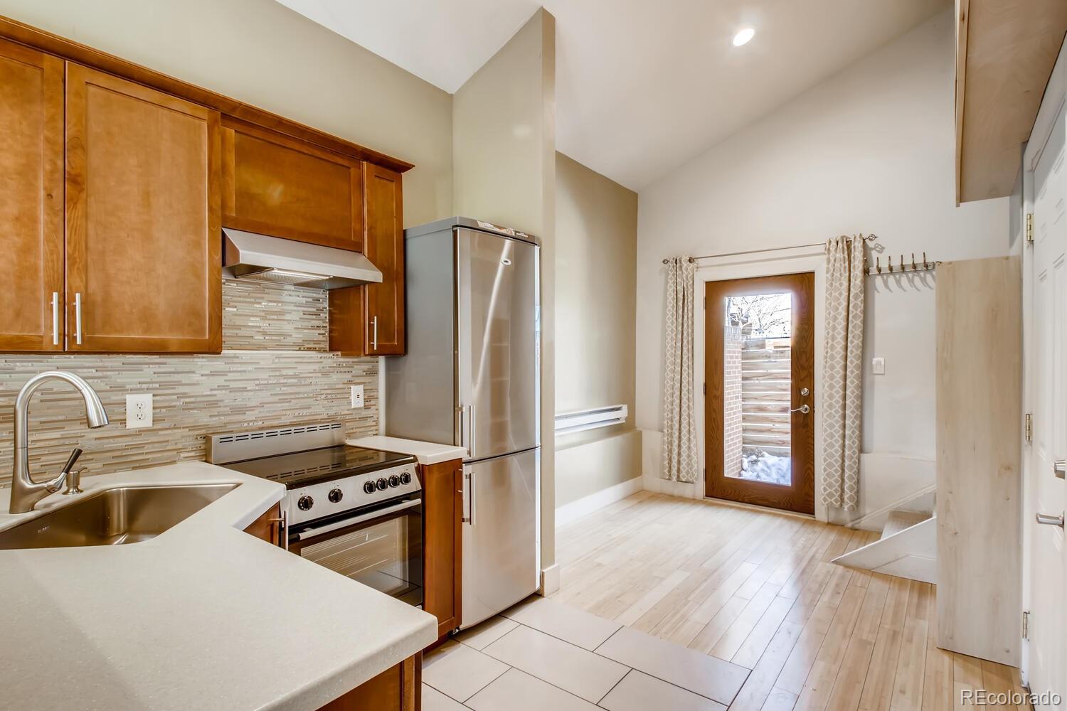 1635 Gilpin Street Denver, CO 80218 - Photo 28 of 39 a kitchen with a refrigerator a sink and a stove