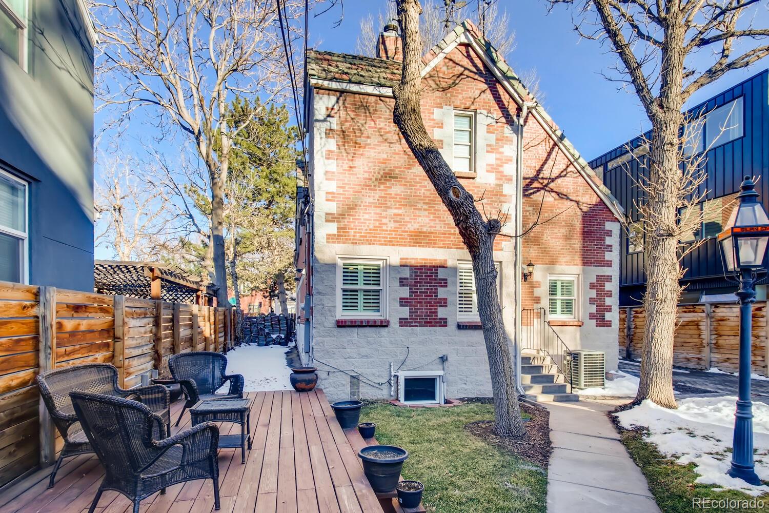 1635 Gilpin Street Denver, CO 80218 - Photo 35 of 39 a view of a patio with couches and table and chairs next to a building