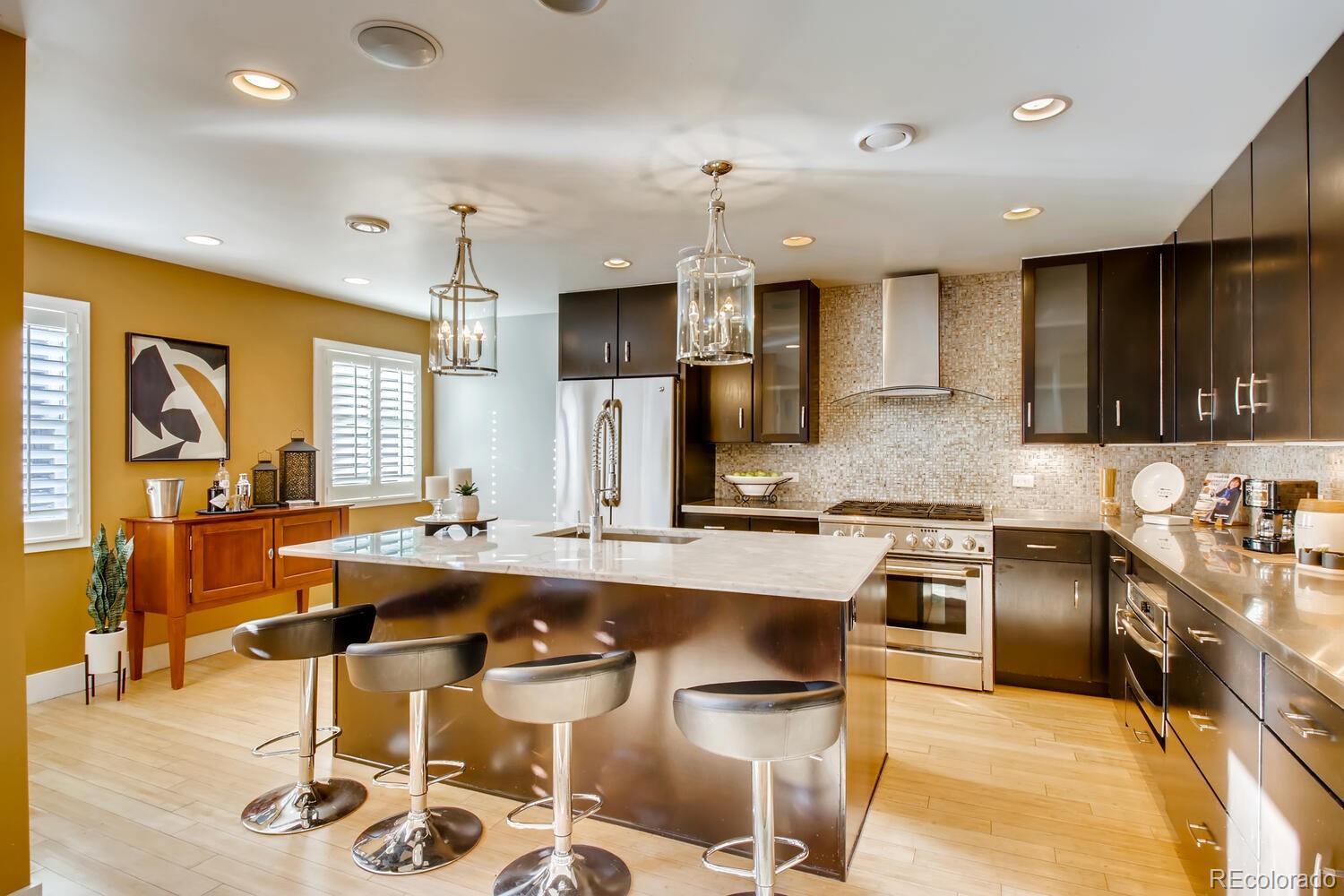 1635 Gilpin Street Denver, CO 80218 - Photo 10 of 39 a large kitchen with a table and chairs in it