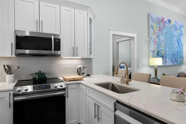 a kitchen with cabinets a sink and a stove top oven