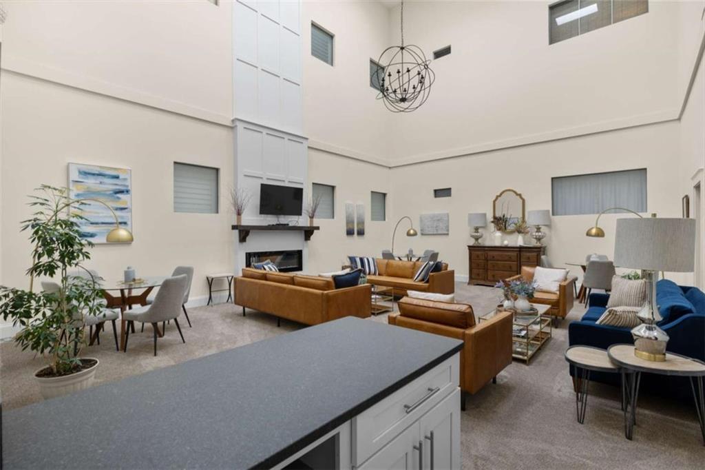 1 East 3rd Avenue, Unit 310 Rome, GA 30161 - Photo 21 of 25 a living room with furniture kitchen view and a flat screen tv