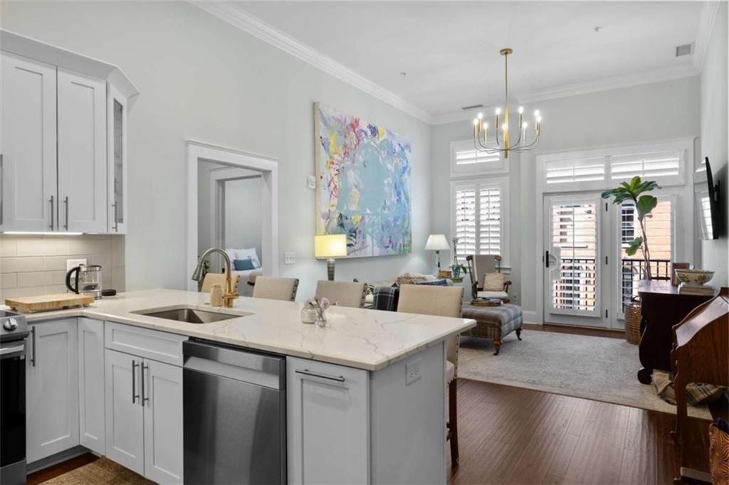 1 East 3rd Avenue, Unit 310 Rome, GA 30161 - Photo 7 of 25 a view of center kitchen island a sink and a chandelier