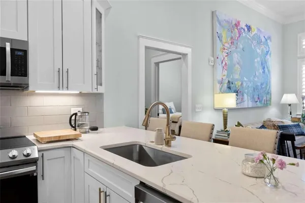 a kitchen with a sink cabinets and a stove top oven