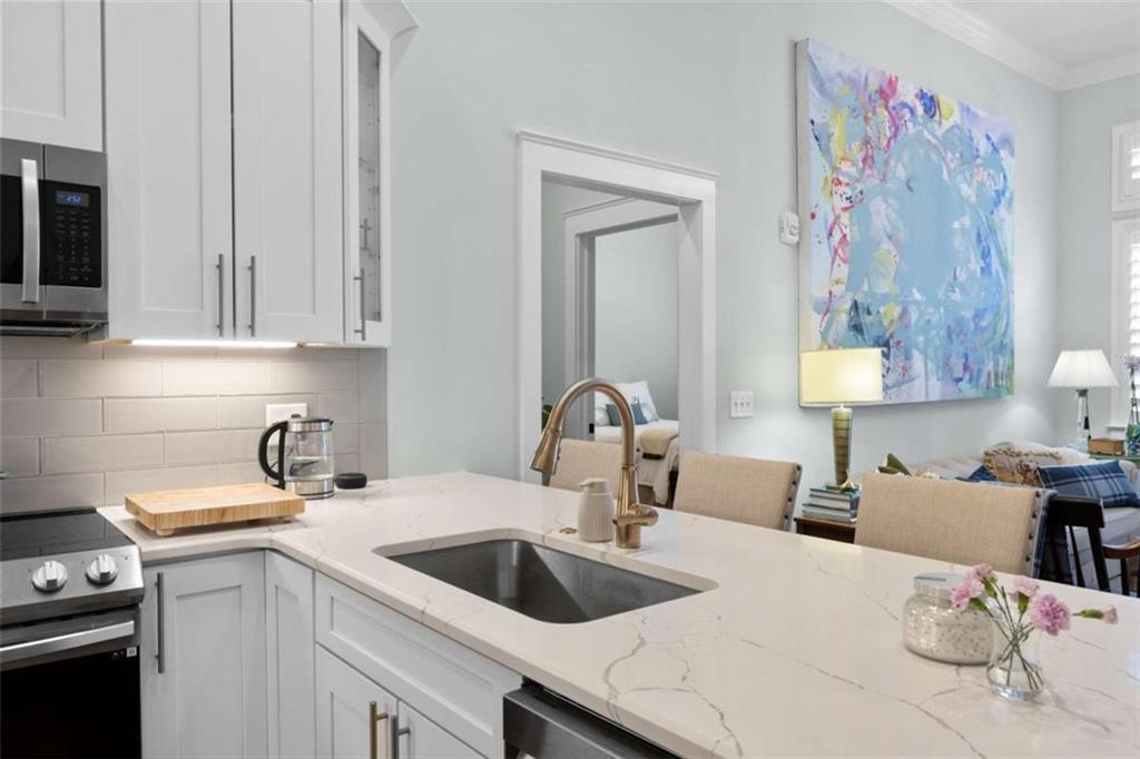 1 East 3rd Avenue, Unit 310 Rome, GA 30161 - Photo 9 of 25 a kitchen with a sink cabinets and a stove top oven