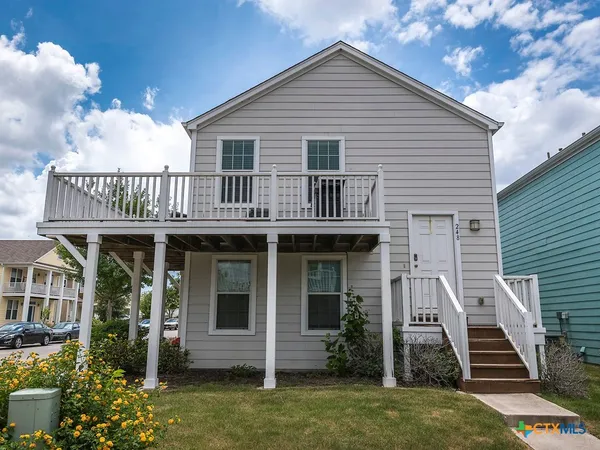 a view of house with front door and deck