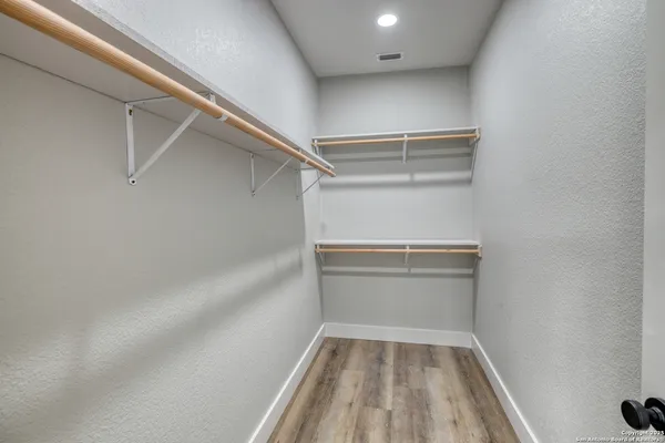 a spacious bathroom with a double vanity sink and mirror