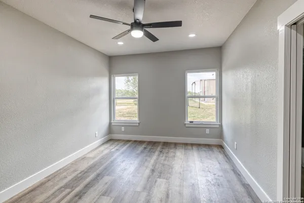 a big white house with a big yard and large trees
