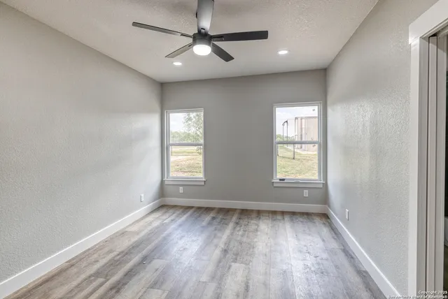 a big white house with a big yard and large trees