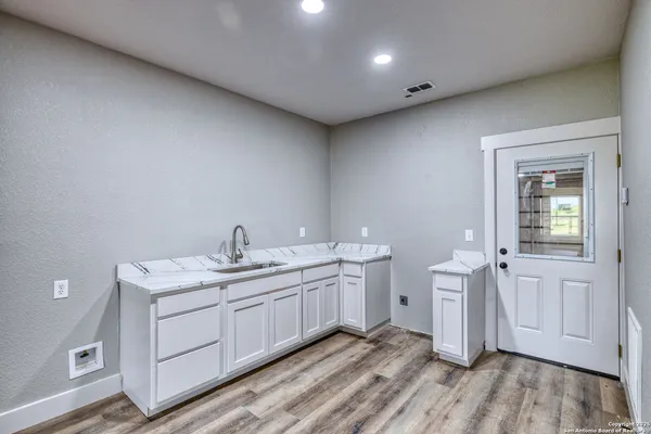 a view of a house with a backyard