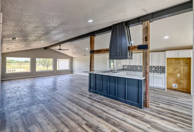 a view of kitchen with cabinets and wooden floor