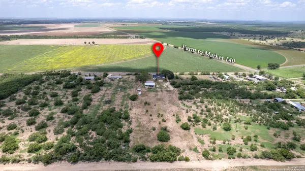 a view of house with a backyard