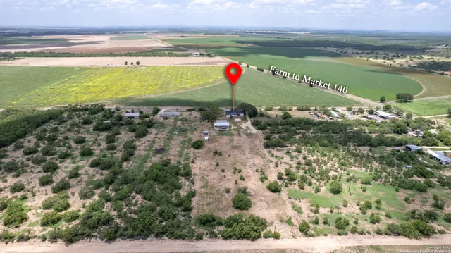 a view of house with a backyard