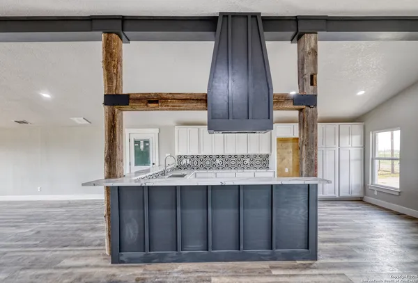 a kitchen with a sink cabinets and wooden floor